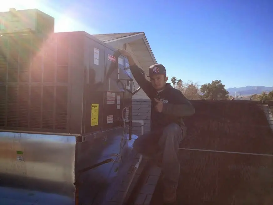 HVAC technician performing AC Tune-Up on a rooftop unit in Santee